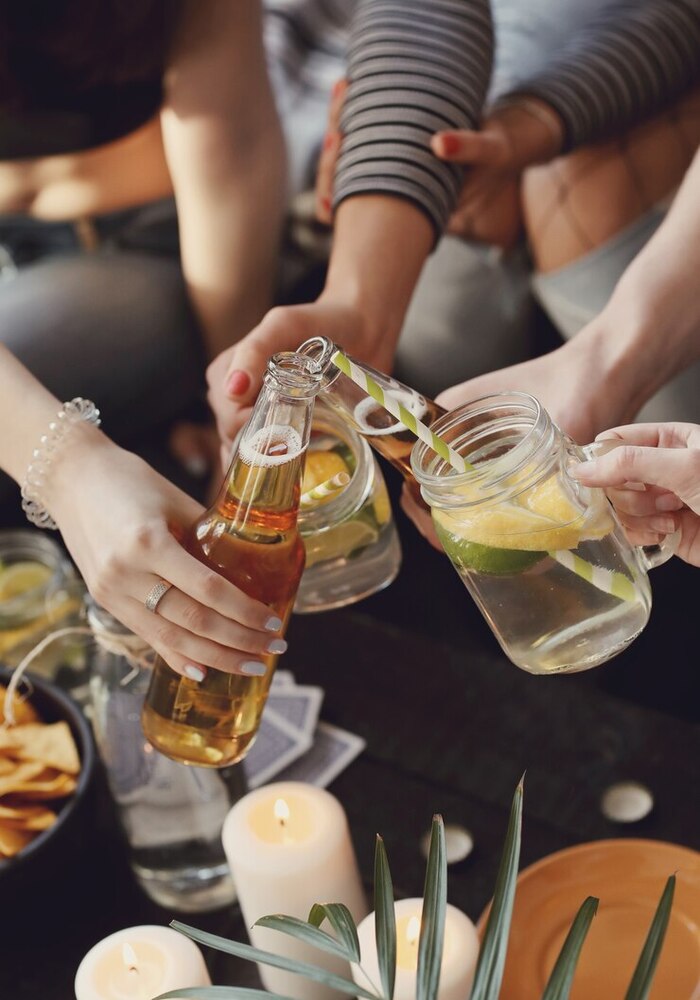 friends toasting eachother with drinks in a lounge setting